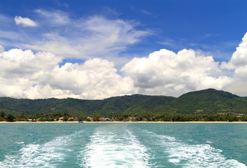 Wake of a ship leaving the coastline
