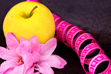 beauty and diet: apple, flower, measuring tape