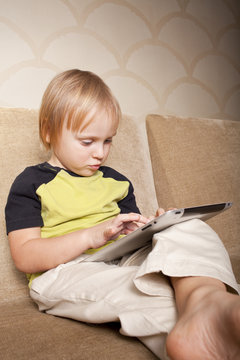 positive small boy with tablet computer