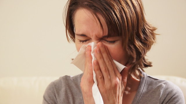 Sneezing woman having a cold.