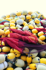 Closeup on fishing net with yellow and white floaters