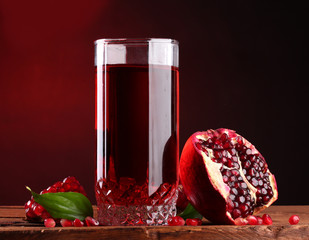 ripe pomergranate and glass of juice