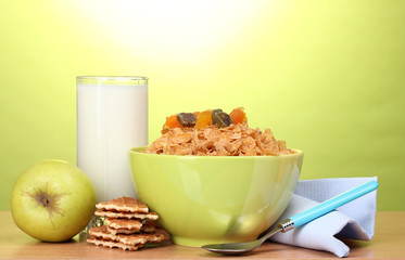 tasty cornflakes in green bowl, apple and glass of milk