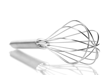 Metal whisk for whipping eggs isolated on white