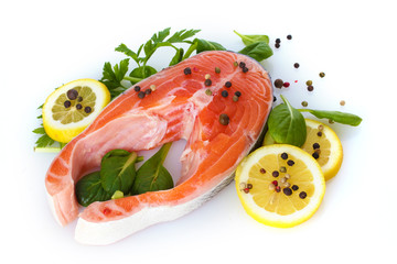 Red fish with lemon, parsley and pepper isolated on white.