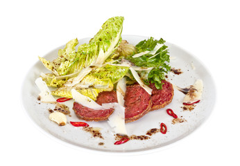 Salad from fried sausages, lettuce with sour cream sauce