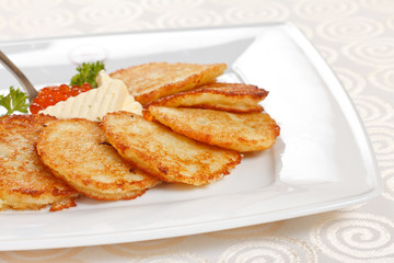 fried potatoes pancakes with caviar