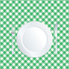 plate on green tablecloth