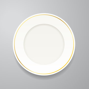 White plate with gold rim on grey