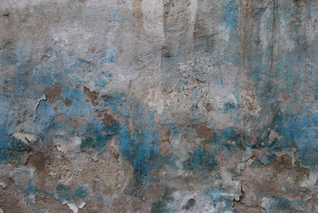 Old crumbled plastered wall faded paint as background