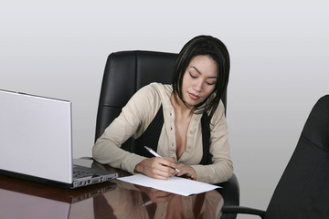 brunette working at her office desk