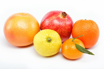 pomegranates and citrus fruits isolated on a white background.