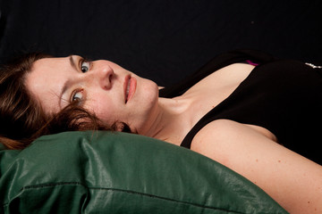Lovely brunette woman in little black dress reclining