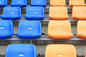 Fototapeta premium plastic, yellow and blue, new chairs in stadium.