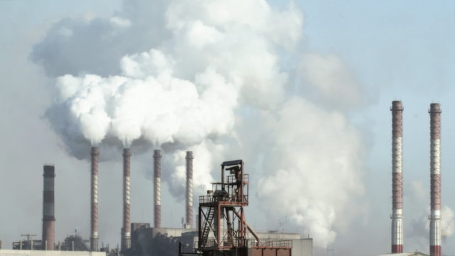 Industrial smokestacks pollute atmosphere