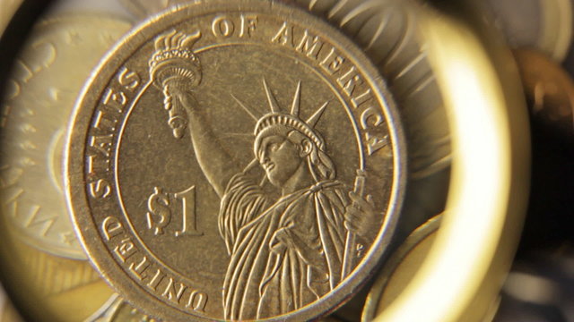 Coin one dollar under magnifying glass