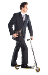 successful man in business suit who rides a scooter