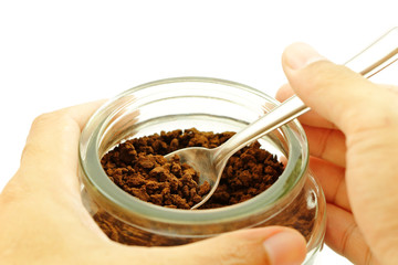 Coffee scoop with a spoon in a glass jar