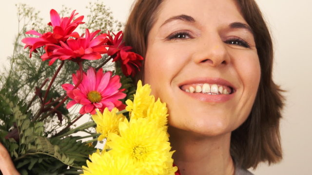 Happy smiling woman with flowers.
