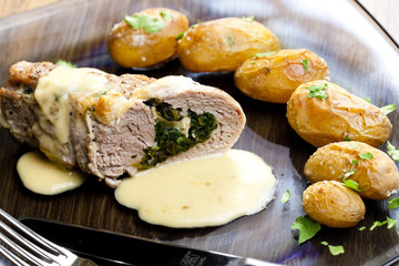 baked pork tenderloin filled with spinach and goat cheese on cre