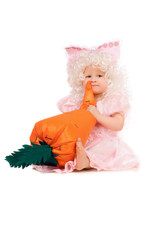 Baby girl plays with a carrot. Isolated