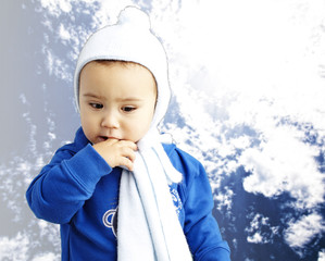 portrait of serious kid thinking with the finger on his mouth ag