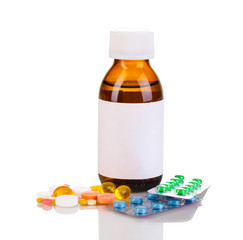 Medical bottle and tablets isolated on white