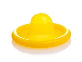 Yellow condom isolated on white