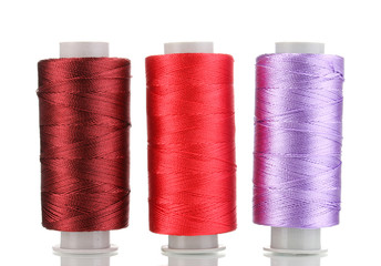 Three bobbin thread isolated on white