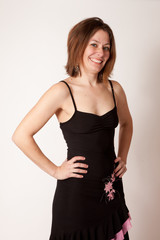 woman in black dress smiling at the camera