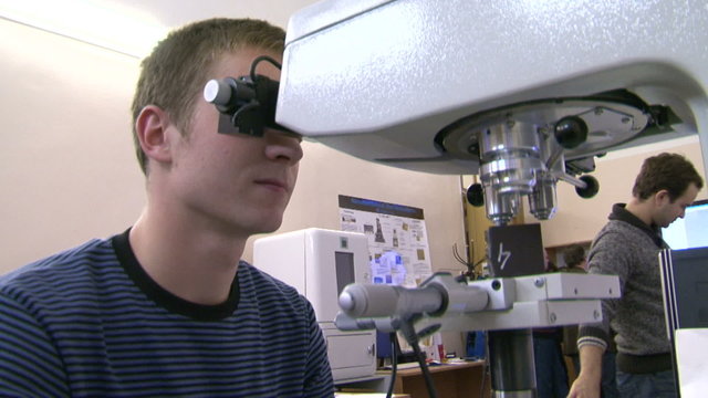 A scientist at the microscope