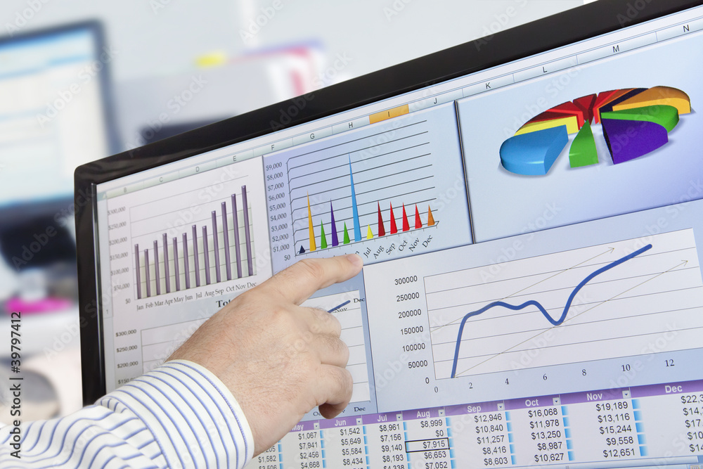 Fototapete Man analyzing financial data and charts on computer screen