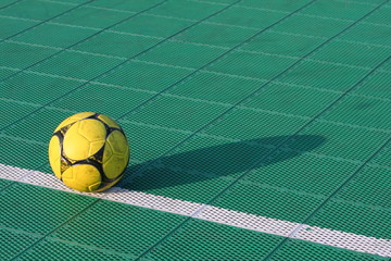 Soccer ball on special outdoor surface field.