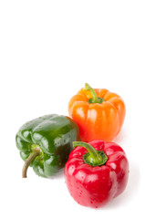 Three different coloured bell peppers, isolated on white