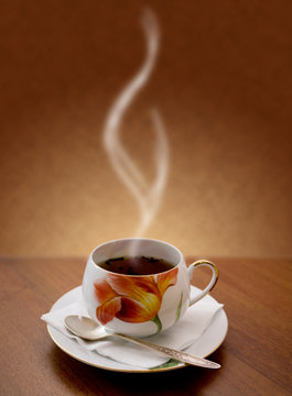 cup of hot tea on a brown background