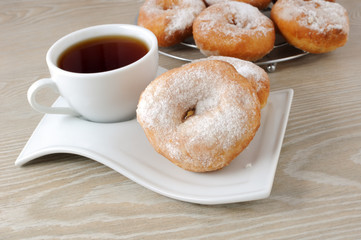 A cup of coffee and donuts