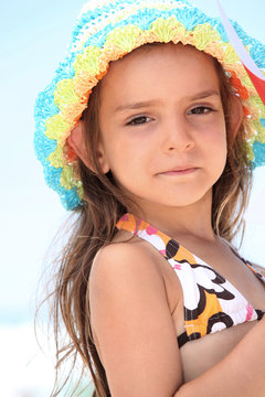 Young girl in a bikini and sunhat