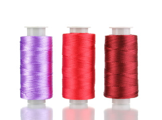 Three bobbin thread isolated on white