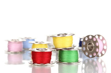 Metal spools of thread isolated on white
