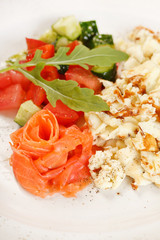 Scrambled eggs with salmon and vegetables