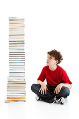 Student sitting close to pile of books on white background