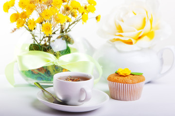 breakfest with tea, cake and yellow flowers