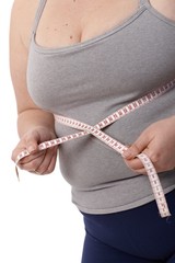 Closeup fat woman measuring waistline