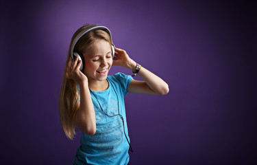 Girl with headphones on purple background