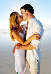 Obraz premium Newlywed couple intimate kissing on honeymoon,