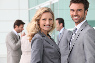 Businessman and woman smiling