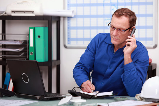 Mechanic On Phone In Office