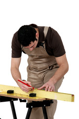 Man measuring wooden plank