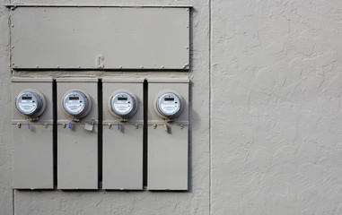 Four Electric Meters gray wall