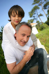 Little boy sat on his father's shoulders